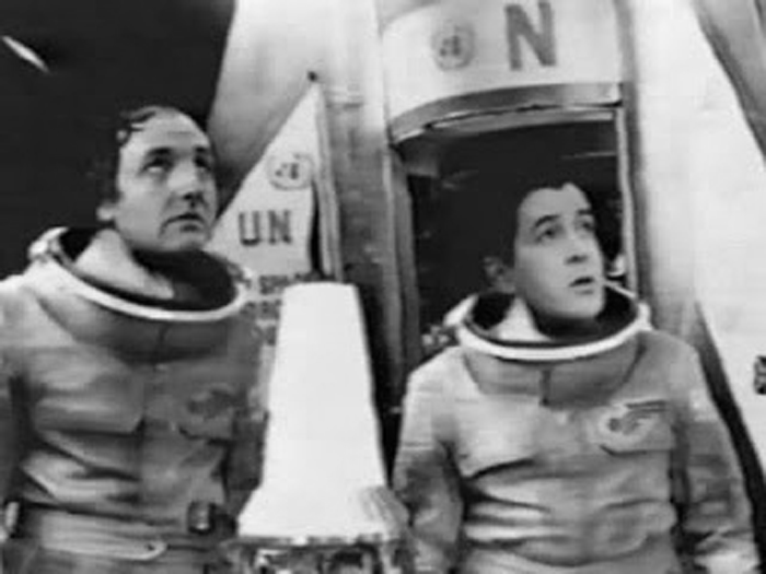 Cory and Lowry demonstrating how not to wear helmets on an alien world, by not wearing them.