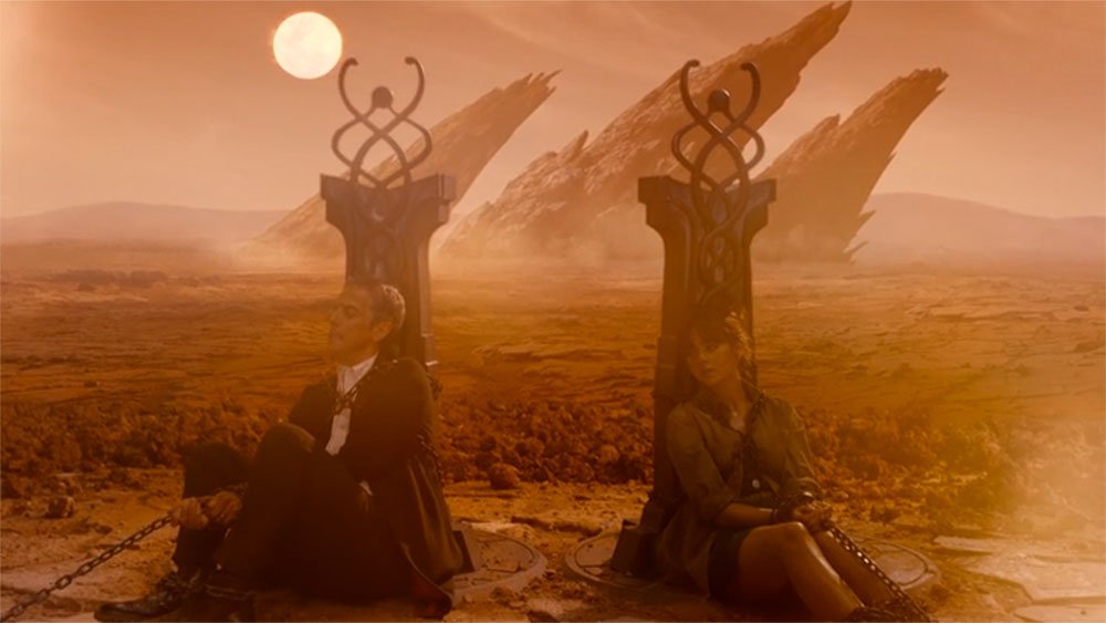 capaldi-twelve-and-clara-tied-up-on-alien-planet-caretaker-doctor-who-back-when
