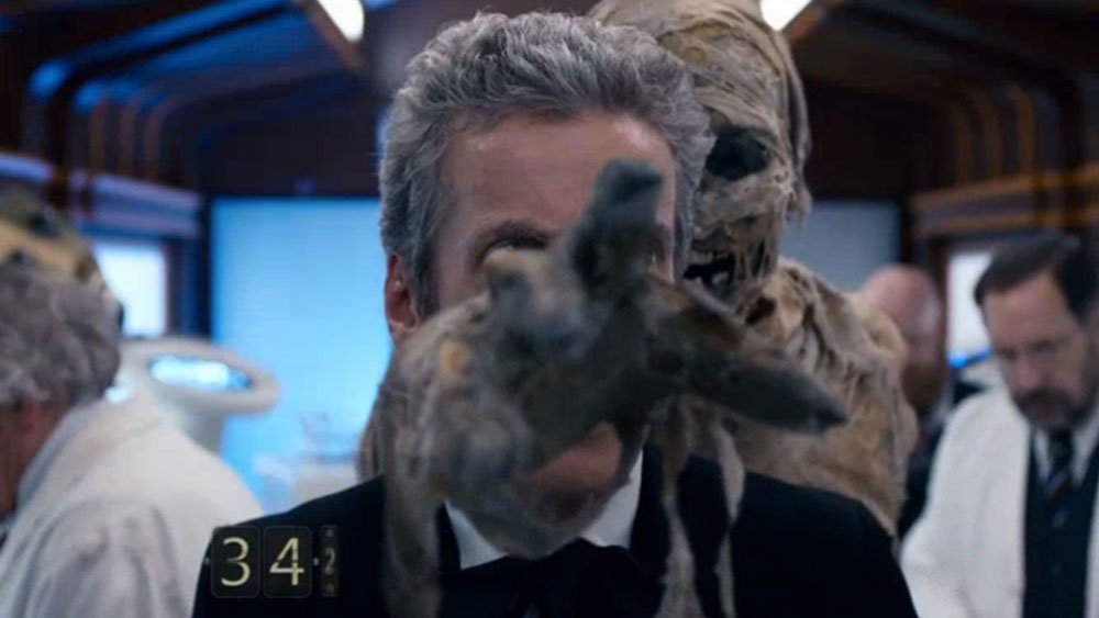 creepy-space-soldier-reaches-through-capaldi-twelve-mummy-on-the-orient-express-doctor-who-back-when