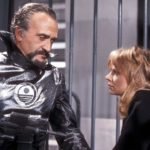 Roger Delgado in his last appearance as the master holds companion Jo Grant at gunpoint
