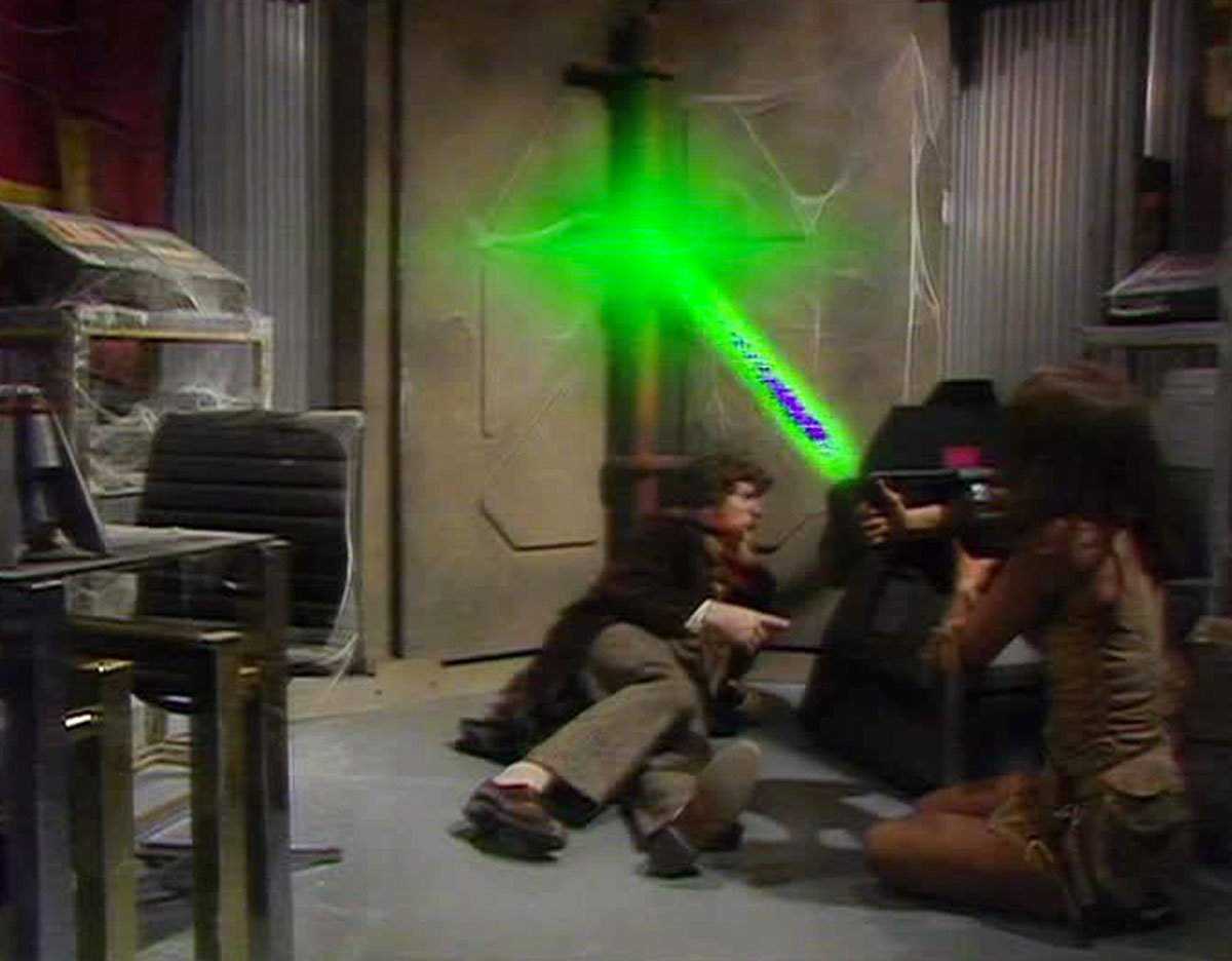 tom-baker-four-and-companion-leela-use-a-shield-laser-gun-on-a-door-underworld-doctor-who-back-when