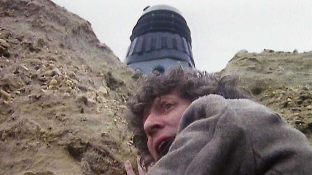 tom-baker-fourth-hangs-from-cliff-while-dalek-nazguls-above-destiny-of-the-daleks-doctor-who-back-when